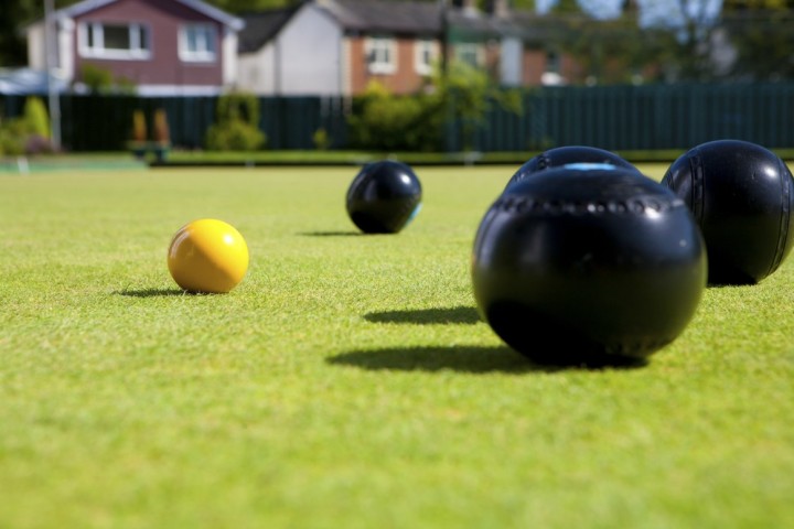 A ground level view of bowls on an outdoor bowling green