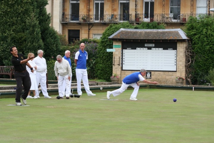 A group of men playing bowls together outdoors