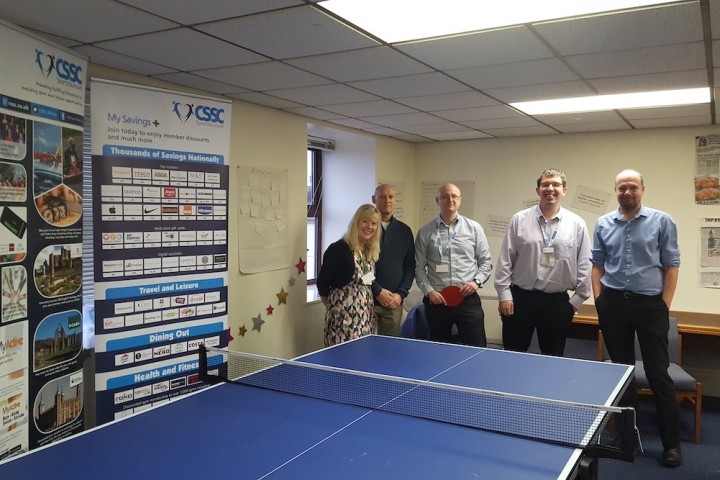 Colleagues posing with a gifted table tennis table